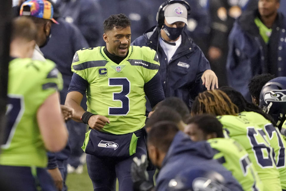 Seattle Seahawks quarterback Russell Wilson (3) talks with teammates on the bench during the first half of an NFL football game, Sunday, Oct. 11, 2020, in Seattle. (AP Photo/Ted S. Warren)