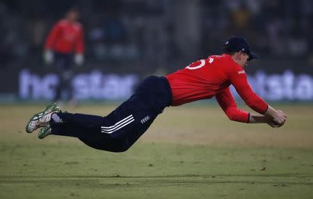 Cricket - England v New Zealand - World Twenty20 cricket tournament semi-final - New Delhi, India - 30/03/2016. England's captain Eoin Morgan dives to take a catch to dismiss New Zealand's Ross Taylor. REUTERS/Adnan Abidi