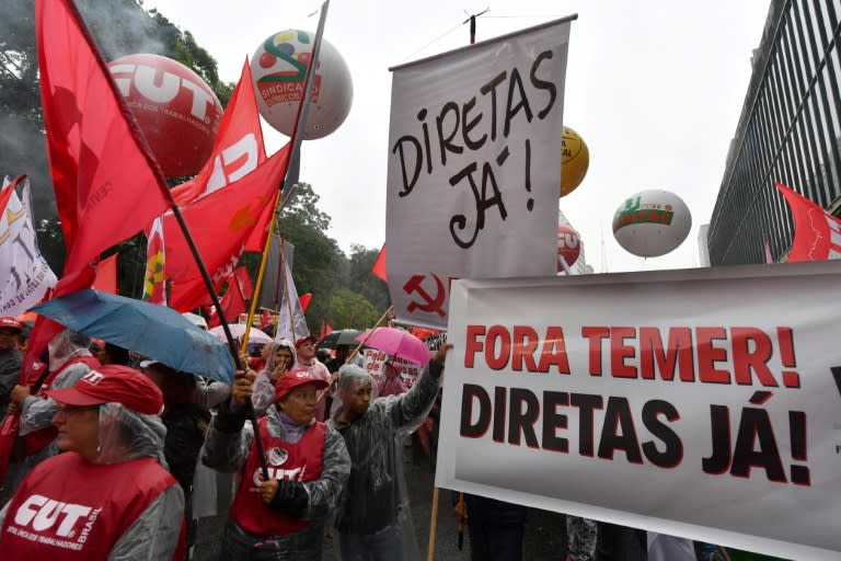 Demonstrators protest against Brazilian President Michel Temer along Paulista Avenue in Sao Paulo Brazil on May 21, 2017