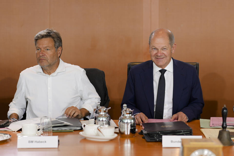 German Chancellor Olaf Scholz, right, and German Economy and Climate Minister Robert Habeck, right, attend the weekly cabinet meeting of the German Government at the chancellery in Berlin, Germany, Wednesday, Aug. 24, 2022. (AP Photo/Markus Schreiber)