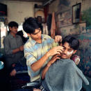 <p>A young Indian man has a close shave in a barbershop in New Delhi, India. </p>