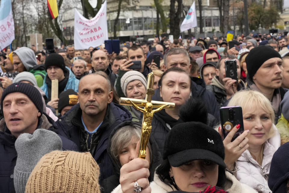 Demonstrators gather to protest against COVID-19 restrictions and vaccine mandates in Kyiv, Ukraine, Wednesday, Nov. 3, 2021. In a bid to stem contagion, Ukrainian authorities have required teachers, government employees and other workers to get fully vaccinated by Nov. 8 or face having their salary payments suspended. In addition, proof of vaccination or a negative test is now required to board planes, trains and long-distance buses. (AP Photo/Efrem Lukatsky)