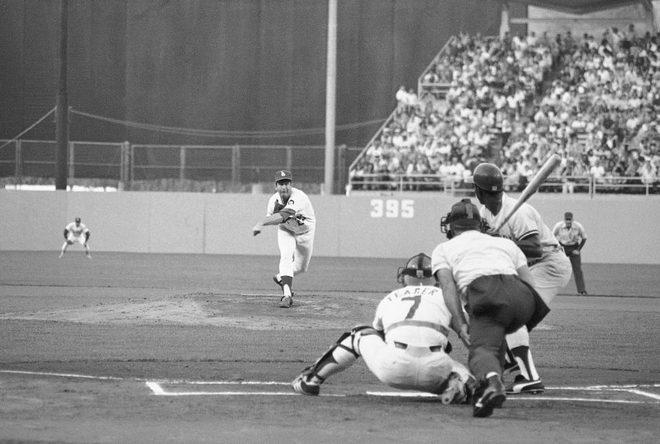 Dodgers pitcher Tommy John delivers the first pitch in Game 1 of the World Series, Tuesday, Oct. 10, 1978 in Los Angeles. Batting is New York Yankees Mickey Rivers. The umpire is Ed Vargo. Catching for the Dodgers is Steve Yeager. First pitch was a called strike.