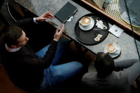 FILE PHOTO: Customers enjoy their coffee at Caffe Nero in Manchester, Britain, April 28, 2017. REUTERS/Jason Cairnduff/File Photo