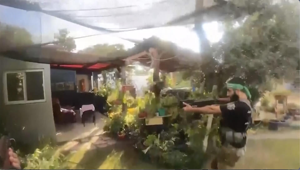 This image made from undated bodycam video footage taken by a downed Hamas militant and released by Israel Defense Forces shows a Hamas militant walking around a residential neighborhood at an undisclosed location in southern Israel. Israel's military brought together a group of foreign correspondents Monday, Oct. 16, 2023, to screen a 40-minute reel of gruesome footage compiled from the Hamas attack last week. The screening came as Israel's military faces increasing pressure to back up their claims of atrocities committed by the militants. (Israel Defense Forces via AP)