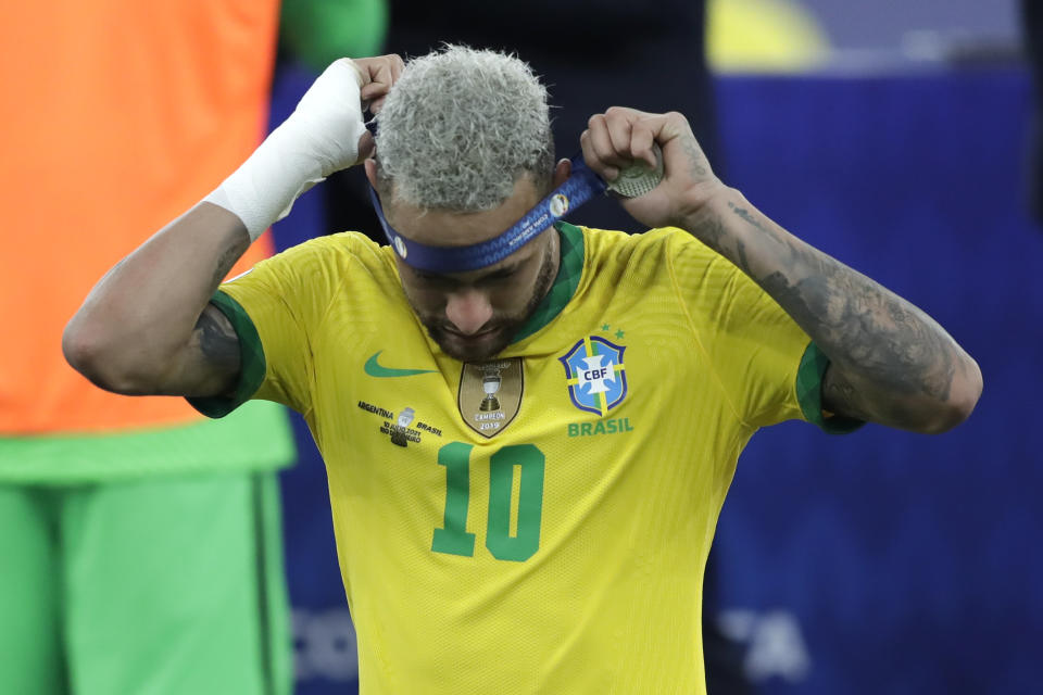 Brazil's Neymar takes off the second place medal during the award ceremony for the Copa America at Maracana stadium in Rio de Janeiro, Brazil, Saturday, July 10, 2021. Brazil lost 0-1 against Argentina. (AP Photo/Andre Penner)