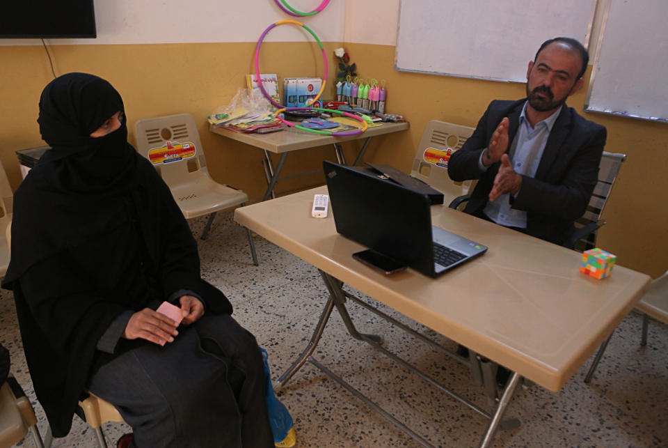 In this Feb. 26, 2019 photo, a widow of Islamic State group militant, Muthanna Hussein, listens to legal advice, at a clinic supported by the Norwegian Refugee Council, in west Mosul, Iraq. Thousands of Iraqi families face crushing social and legal discrimination -- all because of the choices their male relatives made under the Islamic State group’s rule. They’ve been disowned by relatives and abandoned by the state. Registrars refuse to register their births, marriages or divorces; schools won’t let their children enroll. (AP Photo/Khalid Mohammed)