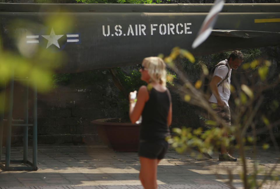 In this Feb. 21, 2019, photo, visitors walk next to an American helicopter at the Vietnam Military History Museum in Hanoi, Vietnam. The Vietnamese capital once trembled as waves of American bombers unleashed their payloads, but when Kim Jong Un arrives here for his summit with President Donald Trump he won’t find rancor toward a former enemy. Instead, the North Korean leader will get a glimpse at the potential rewards of reconciliation. (AP Photo/Hau Dinh)