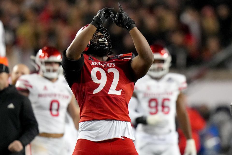Cincinnati Bearcats defensive lineman Curtis Brooks (92) celebrates a sack in the fourth quarter during the American Athletic Conference championship football game, Saturday, Dec. 4, 2021, at Nippert Stadium in Cincinnati. The Cincinnati Bearcats won, 35-20. 
