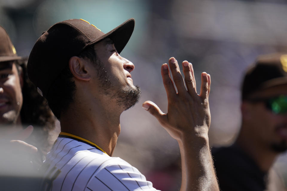 San Diego Padres starting pitcher Yu Darvish reacts in the dugout during the seventh inning of the first baseball game of a doubleheader against the Colorado Rockies, Tuesday, Aug. 2, 2022, in San Diego. (AP Photo/Gregory Bull)