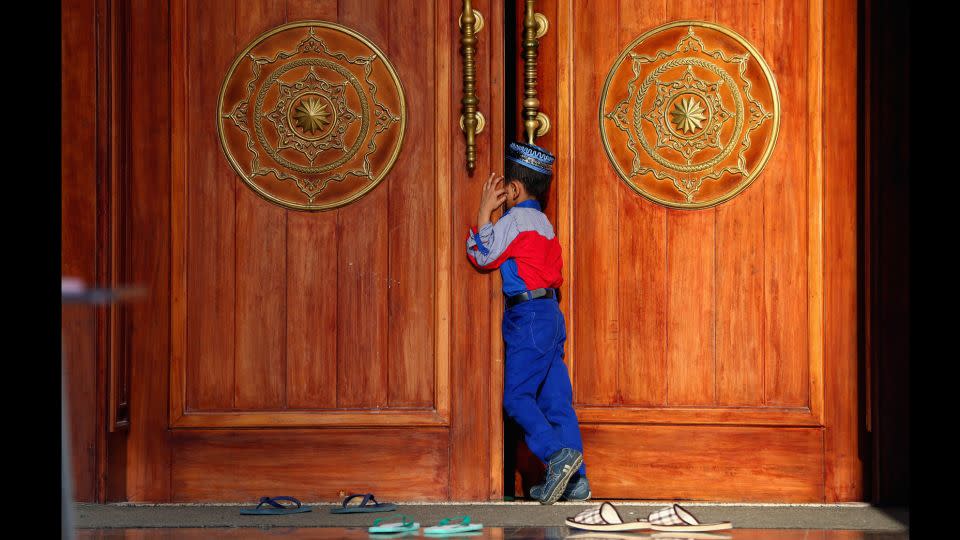 A boy attends the early morning prayer at  Al Noor Mosque  in Sharjah, UAE.  - Francois Nel/Getty Images