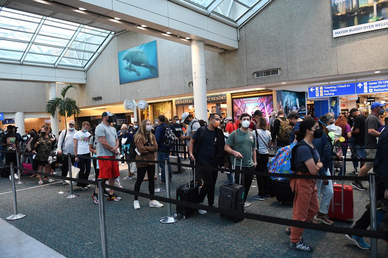 Spring break passengers wait in a TSA security line at Orlando International Airport