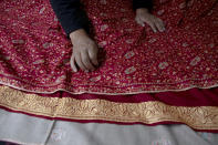An artisan checks the quality of a pashmina shawl inside his home in Srinagar, Indian controlled Kashmir, Saturday, June 13, 2020. A months-long military standoff between India and China has taken a dire toll on local communities as tens of thousands of Himalayan goat kids die because they couldn't reach traditional winter grazing lands, officials and residents said. Nomads have roamed these lands atop the roof of the world for centuries, herding the famed and hardy goats that produce the ultra-soft wool known as Pashmina, the finest of cashmeres. Cashmere takes its name from the disputed Kashmir valley, where artisans weave the wool into fine yarn and exquisite shawls that cost up to $1,000 apiece in world fashion capitals in a major handicraft export industry that employs thousands. (AP Photo/Dar Yasin)