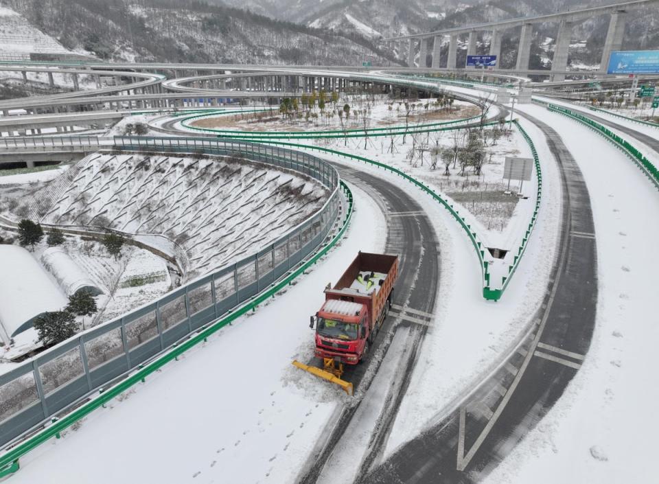 A vehicle removing snow from a highway following snowfall in Baokang (Reuters)