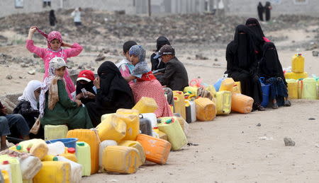 People wait to collect water from a public tap amidst an acute water shortage in Sanaa May 13, 2015. REUTERS/Mohamed al-Sayaghi