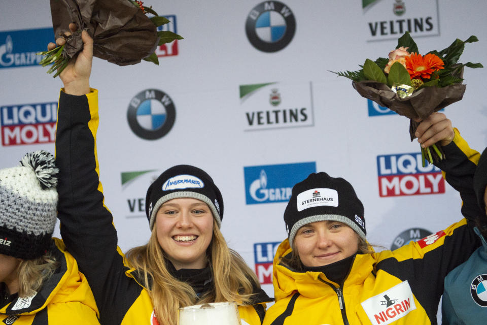 Ann-Christin Strack, left, and Stephanie Schneider, celebrate after winning the women's bobsled World Cup race in Winterberg, Germany, Saturday, Dec. 15, 2018. (Christophe Gateau/dpa via AP)