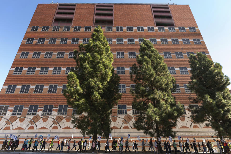 People participate in a protest outside of the University of California Los Angeles, UCLA campus in Los Angeles, Monday, Nov. 14, 2022. Nearly 48,000 unionized academic workers at all 10 University of California campuses have walked off the job Monday. (AP Photo/Damian Dovarganes)