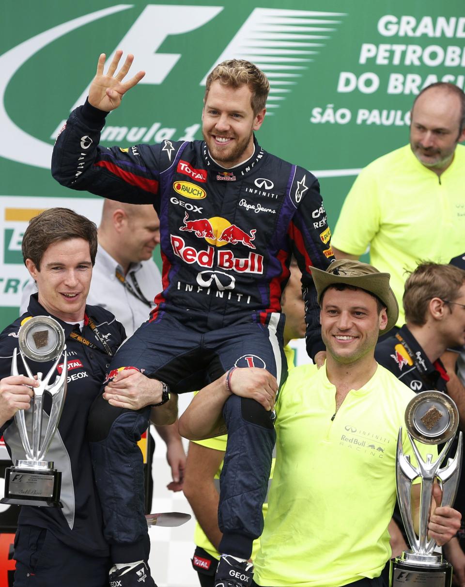 Sebastian Vettel of Germany ackowledges the crowd as the Red Bull team celebrates their win in the F1 Grand Prix, after the Brazilian F1 Grand Prix at the Interlagos circuit in Sao Paulo