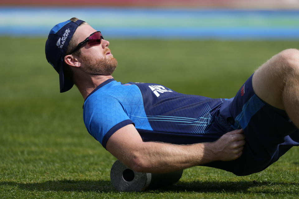 New Zealand's Jimmy Neesham stretches before the ICC Men's Cricket World Cup match between India and New Zealand in Dharamshala, India, Sunday, Oct. 22, 2023. (AP Photo/Ashwini Bhatia)