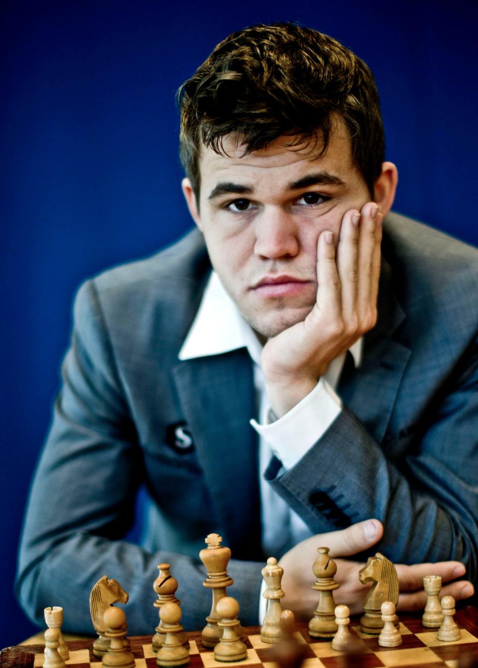 Magnus Carlsen poses for a portrait in front of a chess set in 2013.