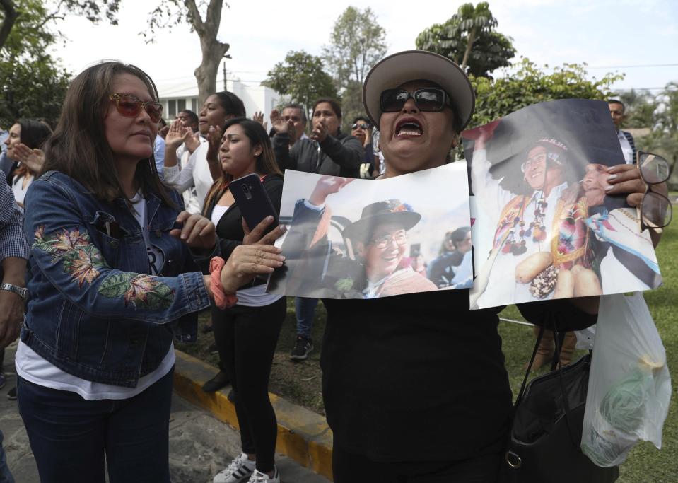 Supporters of Peru’s former President Alberto Fujimori shout slogans as they hold photos of him, outside Fujimori's home in Lima, Peru, Wednesday, Oct. 3, 2018. Peru's Supreme Court has overturned a medical pardon for former President Alberto Fujimori and ordered the strongman be returned to jail to serve out a long sentence for human rights abuses. (AP Photo/Martin Mejia)