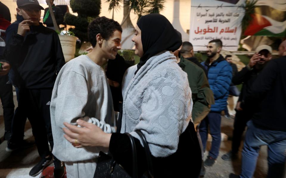 AL BIREH, WEST BANK - NOVEMBER 26: 39 Palestinians, brought by International Committee of the Red Cross vehicle, reunite with their relatives as they are released from Israeli Ofer prison as a part of Israel and Palestinian resistance group Hamas prisoner swap amid Humanitarian pause, according to Palestine Liberation Organization's prisoners in Al Bireh city of Ramallah, West Bank on November 26, 2023. Israeli authorities released 39 Palestinians, including 6 females, 33 minors as part of second batch of prisoner swap according to official Palestinian news agency WAFA. (Photo by Issam Rimawi/Anadolu via Getty Images)