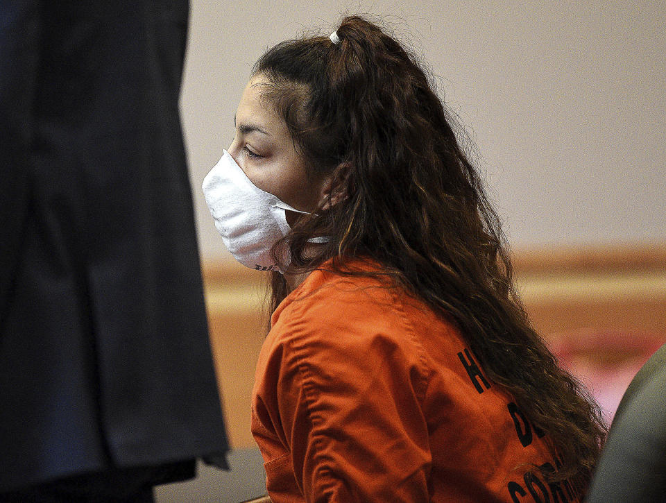 Kayla Montgomery sits as her attorney, Paul Garrity, as he addresses the court at her plea and sentencing hearing at Hillsborough County Superior Court in Manchester, N.H., on Friday, Nov. 18, 2022. Montgomery, the stepmother of a New Hampshire girl who disappeared in 2019 at age 5 and is presumed dead was sent to prison for at least a year and a half Friday after pleading guilty to perjury charges. (David Lane/Union Leader via AP, Pool)