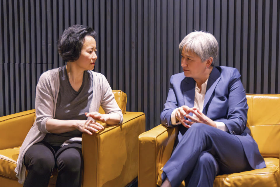 In this photo provided by the Department of Foreign Affairs and Trade, Chinese Australian journalist Cheng Lei, left, speaks with Australia's Minister for Foreign Affairs, Penny Wong, at Tullamarine Airport in Melbourne, on Wednesday, Oct. 11, 2023. Cheng, who was convicted on murky espionage charges and detained in China for three years has returned to Australia. (Sarah Hodges/DFAT via AP)