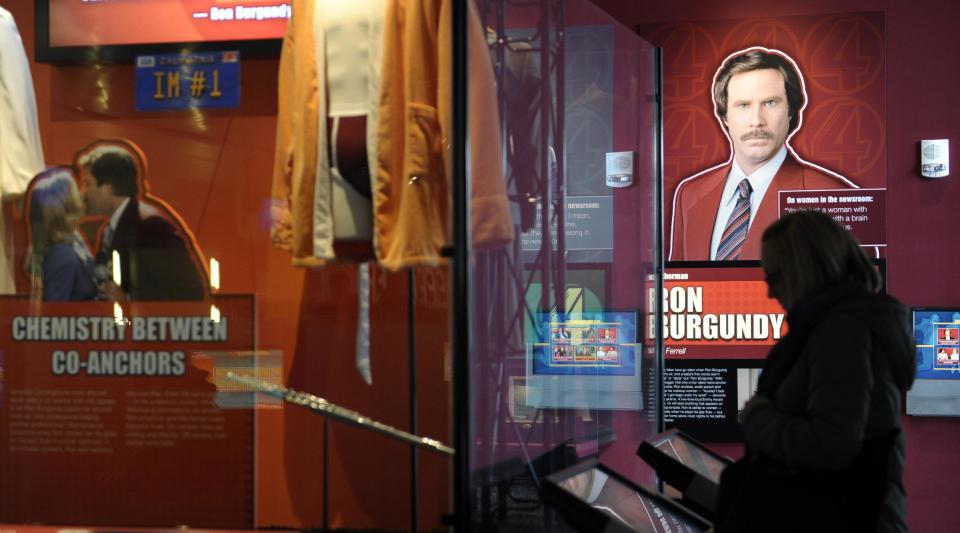 A Newseum visitor looks at the "Anchorman" movie exhibit at the Newseum in Washington, Friday, Nov. 15, 2013. The museum about news and the First Amendment has opened "Anchorman: The Exhibit," featuring costumes and props from Will Ferrell's 2004 movie "Anchorman: The Legend of Ron Burgundy." The story of a fictional news team's sexist reaction to the arrival of an ambitious female reporter was a parody of real tumult in the 1970s TV business. (AP Photo/Susan Walsh)
