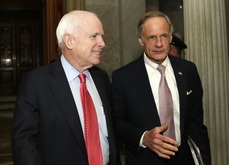 Senators McCain and Carper talk outside of Senate chamber after budget vote on Capitol Hill in Washington