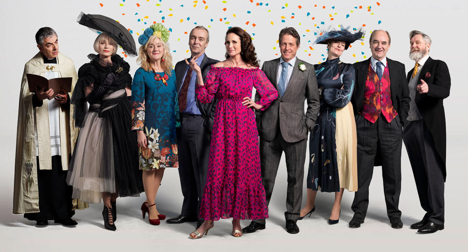 (L to R): Rowan Atkinson (Father Gerald), Kristin Scott Thomas (Fiona), Sophie Thompson (Lydia), John Hannah (Matthew), Andie MacDowell (Carrie), Hugh Grant (Charles), Anna Chancellor (Henrietta), David Haig (Bernard), James Fleet (Tom) – Photographer credit: Greg Williams