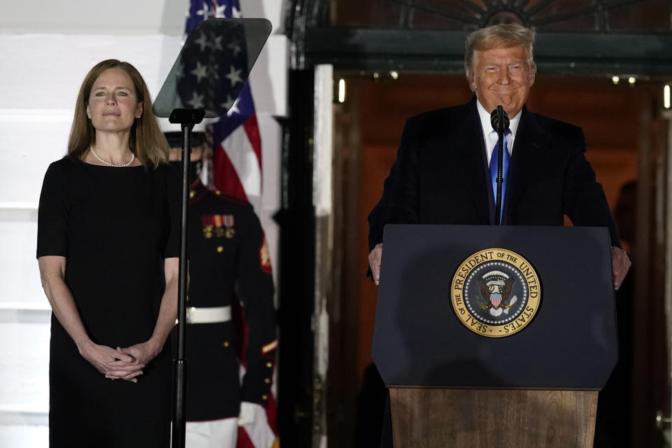 President Donald Trump speaks before Supreme Court Justice Clarence Thomas administers the Constitutional Oath to Amy Coney Barrett on the South Lawn of the White House White House in Washington, Monday, Oct. 26, 2020, after Barrett was confirmed to be a Supreme Court justice by the Senate earlier in the evening. (AP Photo/Alex Brandon)