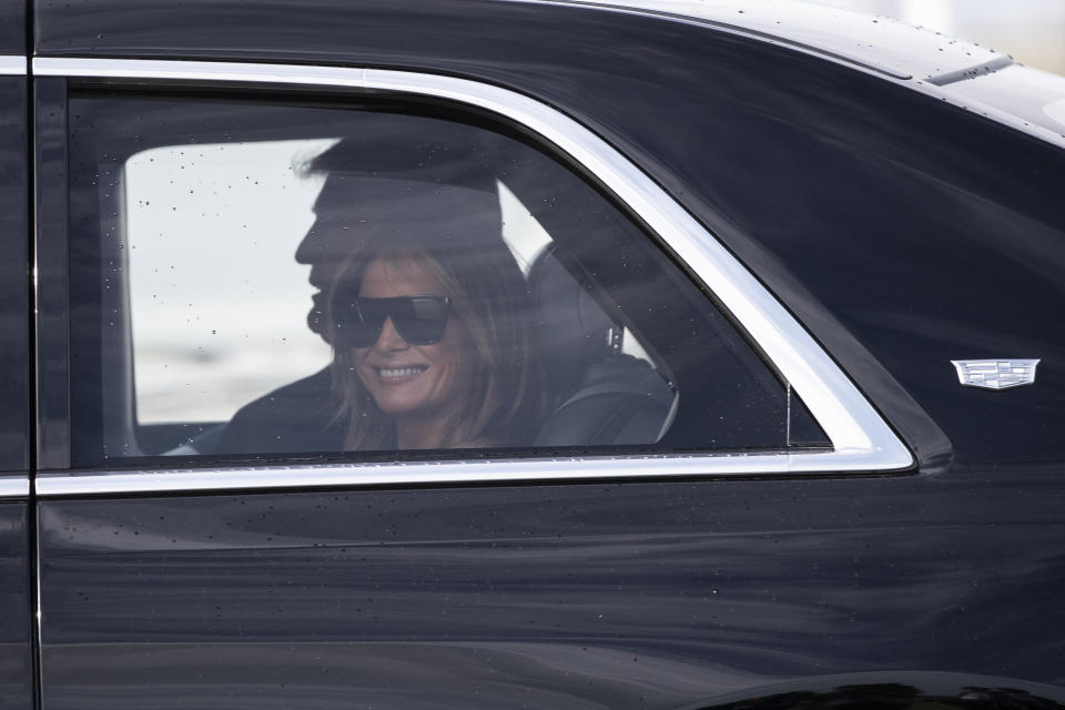 First lady Melania Trump smiles as they head to their planes at Daytona Beach International Airport, Sunday, Feb. 16, 2020, in Daytona Beach, Fla. Trump was at the NASCAR Daytona 500 auto race at Daytona International Speedway. (AP Photo/Alex Brandon)