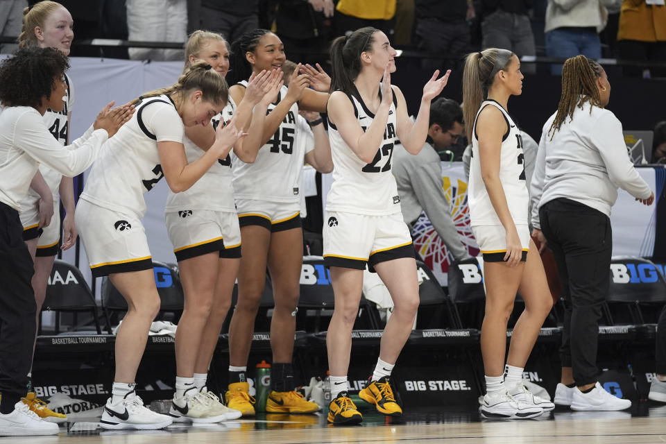 Iowa guard Caitlin Clark, center, celebrates with teammates as time expires in the team's win over Michigan following an NCAA college basketball game in the semifinals of the Big Ten women's tournament Saturday, March 9, 2024, in Minneapolis. (AP Photo/Abbie Parr)