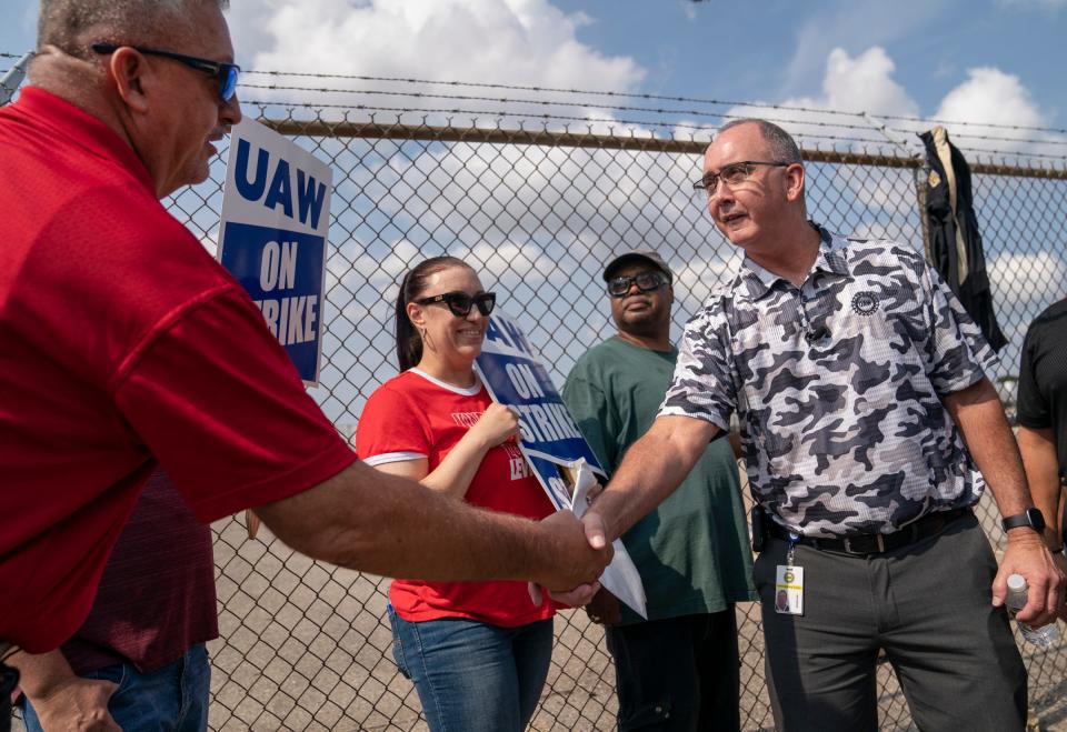 Tony Sadowski UAW Local 889 president, left, shakes hands with UAW President Shawn Fain outside of Center Line Packaging on Friday, Sept. 22, 2023.