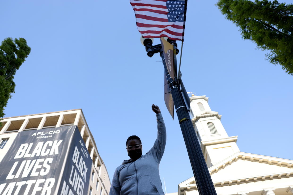 A woman reacts after the verdict in the trial of former Minneapolis police officer Derek Chauvin, found guilty of the death of George Floyd, at BLM Plaza in Washington, D.C., U.S., April 20, 2021. REUTERS/Evelyn Hockstein REFILE - CORRECTING GENDER OF PERSON PICTURED