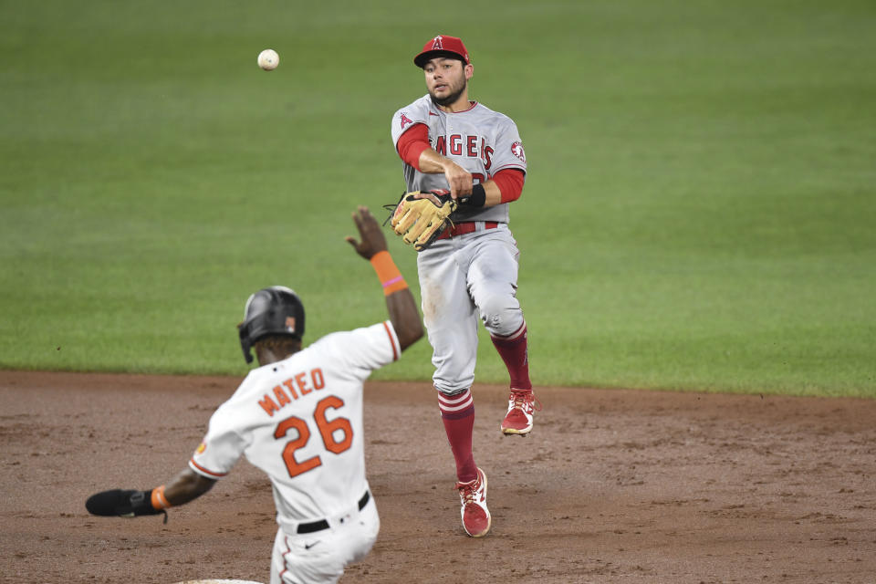 Los Angeles Angels second baseman David Fletcher throws to first base for an out on a ball hit by Baltimore Orioles' Ryan Mountcastle against Los Angeles Angels starting pitcher Dylan Bundy during the second inning of a baseball game Tuesday, Aug. 24, 2021, in Baltimore. (AP Photo/Terrance Williams)