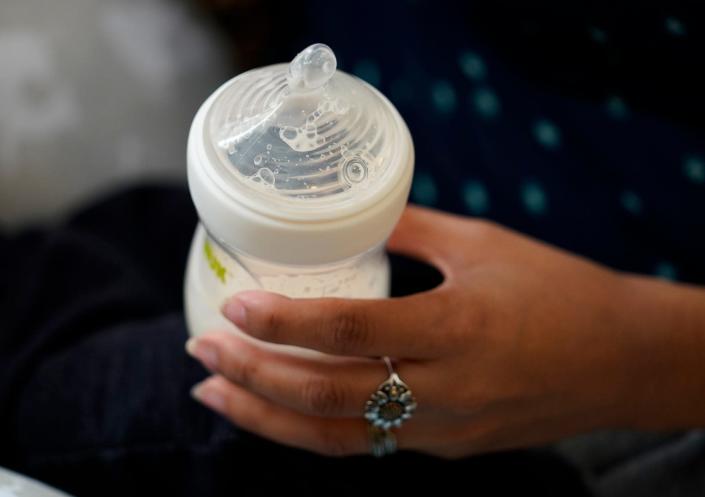 Olivia Godden holds a bottle of baby formula as she feeds her infant son, Jaiden, May 13, 2022, in San Antonio. Godden, who feeds her son 2 ounces of formula every two hours, has reached out to family and friends as well as other moms through social media in efforts to locate needed baby formula which is in short supply.