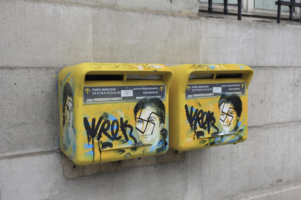 This photo taken on Monday, Feb. 11, 2019 and provided by the Paris city hall of the XIIIth district shows mailboxes with swastikas covering the face of the late Holocaust survivor and renowned French politician, Simone Veil, in Paris, France. According to French authorities, the total of registered anti-Semitic acts rose to 541 in 2018 from 311 in 2017, a rise of 74 percent. (Mairie du XIIIth via AP)