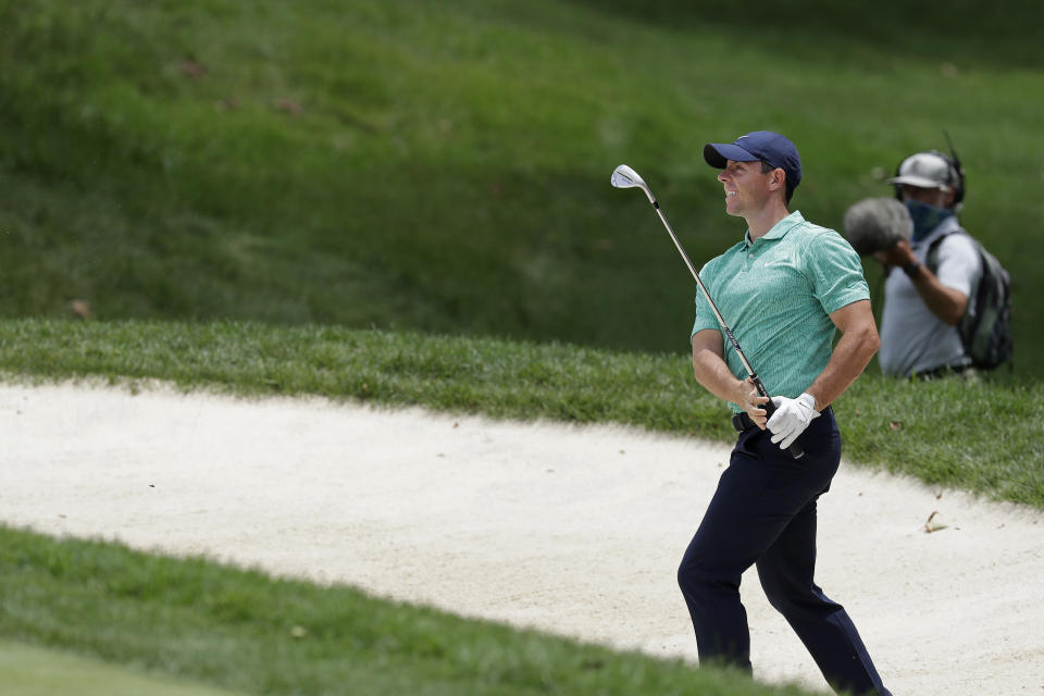 Rory McIlroy, of Northern Ireland, hits from a bunker toward the fourth green during the first round of the Memorial golf tournament, Thursday, July 16, 2020, in Dublin, Ohio. (AP Photo/Darron Cummings)