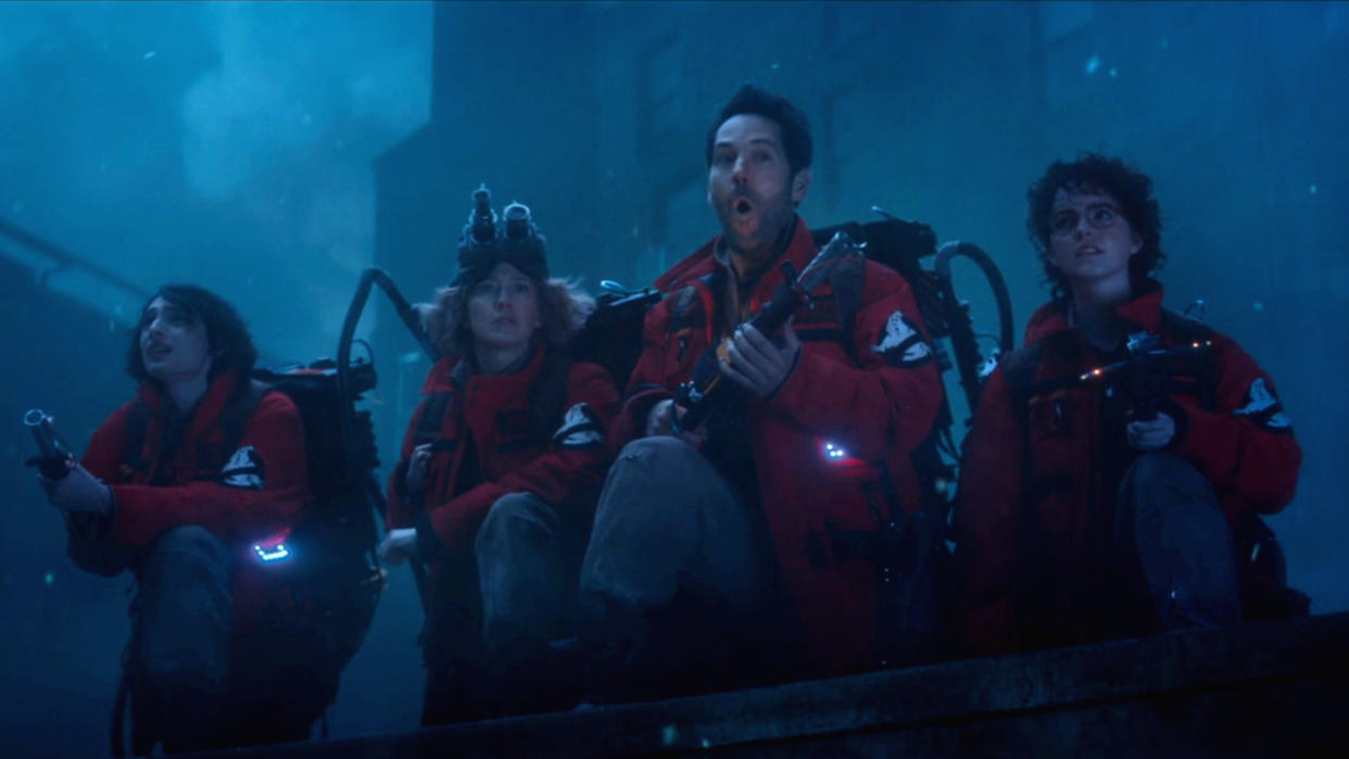  Finn Wolfhard Carrie Coon Paul Rudd and McKenna Grace crouch armed with proton packs in Ghostbusters: Frozen Empire. 