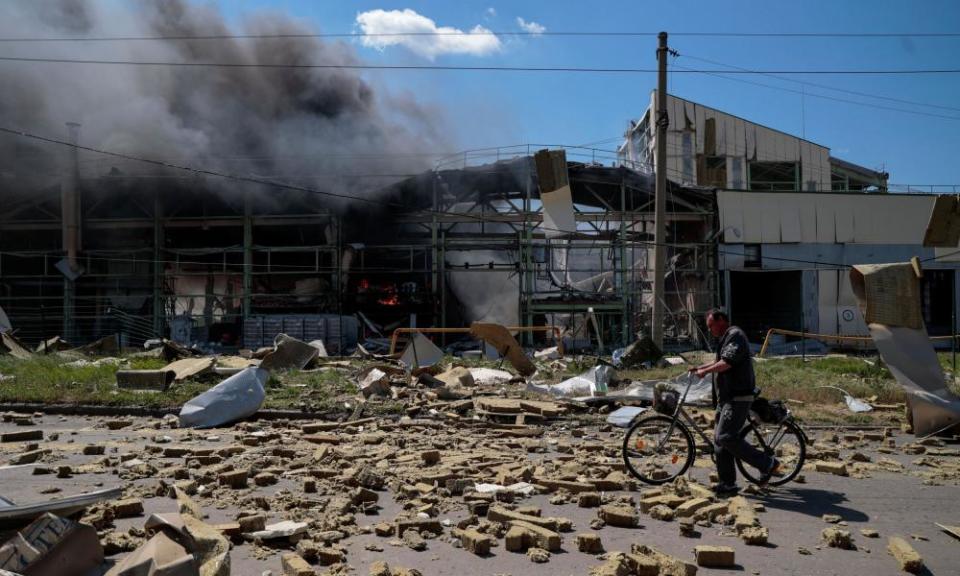 A resident of Bakhmut, a town south-west of Sievierodonetsk, walks past an industrial building damaged by a Russian strike