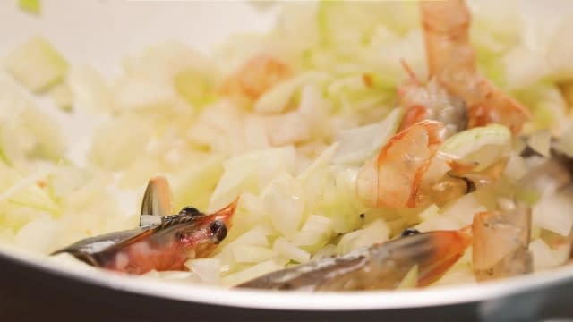 Frying prawn head, shells, and onion