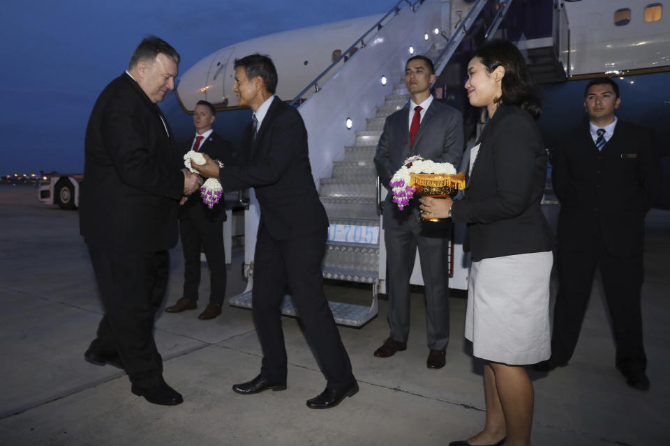 U.S. Secretary of State Mike Pompeo is presented with flowers as he boards his plane to depart for Australia from Don Mueang International Airport, in Bangkok, Thailand, Saturday, Aug. 3, 2019. (Jonathan Ernst/Pool Photo via AP)