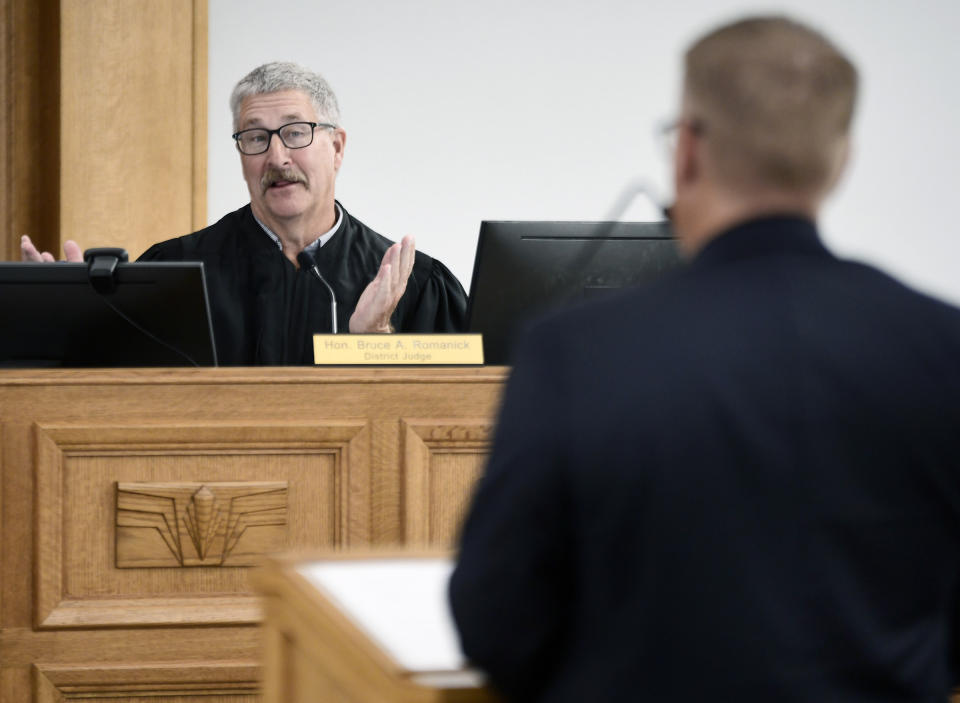 FILE - South Central District Judge Bruce Romanick, left, asks a question during a preliminary injunction hearing regarding banning abortions on Aug. 19, 2022, in Bismarck, N.D. On Monday, Oct. 31, 2022, Romanick affirmed his refusal to let the state’s abortion ban take effect despite the state Supreme Court ordering him to reconsider whether he had made the “appropriate” decision as a lawsuit over the law is pending. (Mike McCleary/The Bismarck Tribune via AP, File)