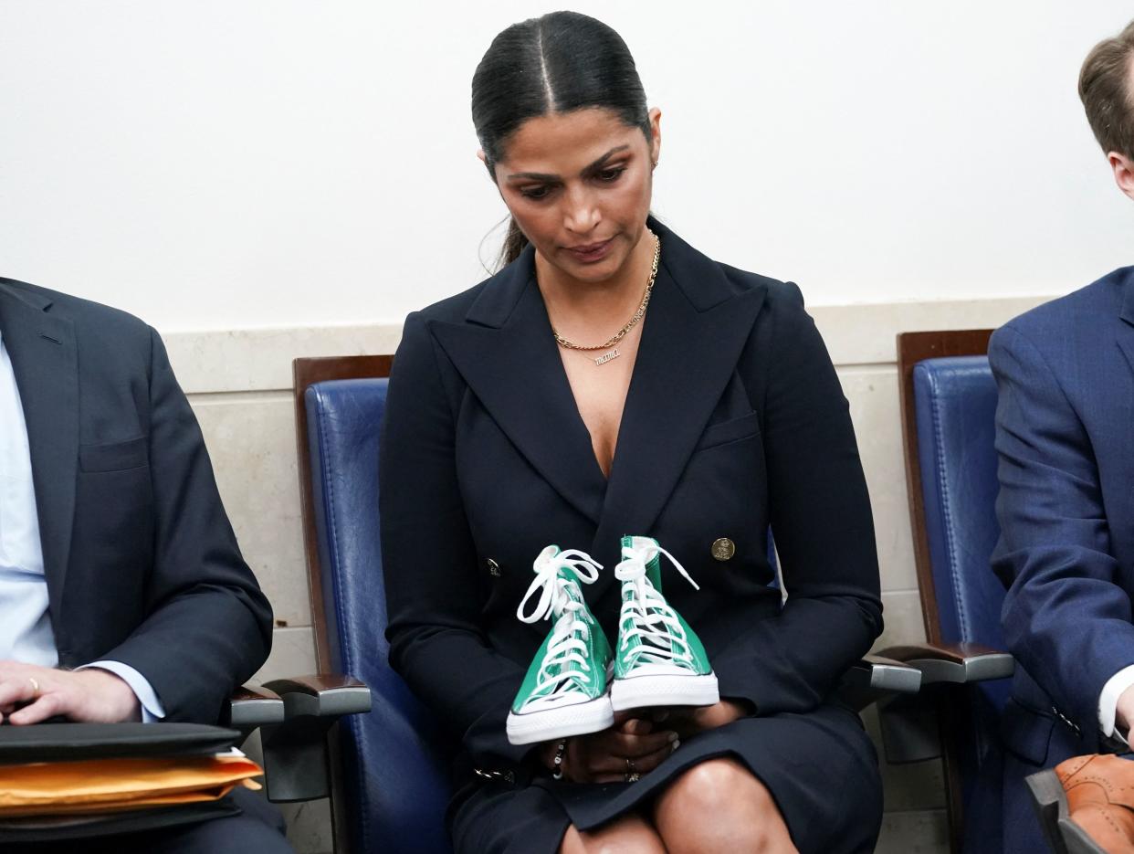 Camila Alves McConaughey, a model, designer and the wife of actor Matthew McConaughey, holds a pair of sneakers used to identify one of the student victims as her husband speaks to reporters about the recent mass shooting at an elementary school in his hometown of Uvalde, Texas during a press briefing at the White House in Washington, U.S., June 7, 2022. REUTERS/Kevin Lamarque