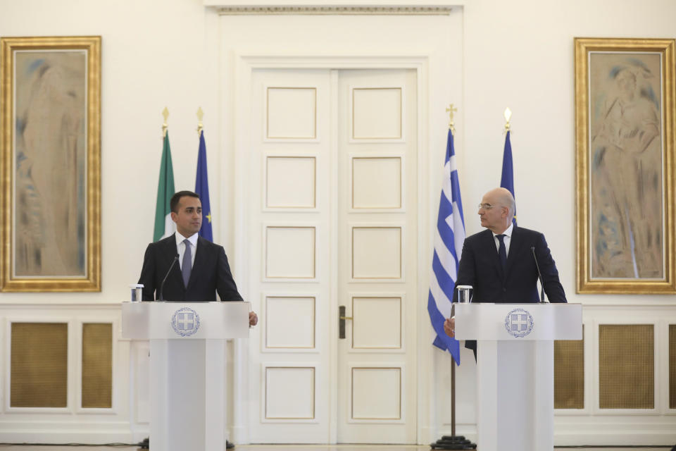 Greek Foreign Minister Nikos Dendias, right, speaks next to his Italian counterpart Luigi Di Maio during a news conference and after their meeting in Athens , on Tuesday, June 9, 2020. Greece will lift all restrictions on Italian tourists entering the country gradually between June 15 and the end of the month, Greece's foreign minister said Tuesday.(Costas Baltas /Pool via AP)