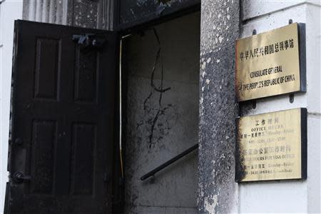 The damaged entrance of the Chinese consulate is seen after an unidentified person set fire to the main gate in San Francisco, California January 2, 2014. REUTERS/Stephen Lam