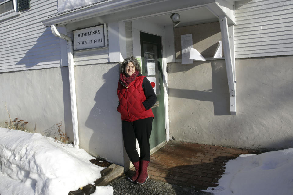 Susan Clark, moderator of the Middlesex town meeting, poses in front of the Middlesex town hall on Thursday, Feb. 25, 2021, in Middlesex, Vt. Clark has studied the traditional New England Town Meeting and says temporary changes during the pandemic could end up further eroding the tradition of representative democracy in town meetings. Vermont's traditional town meeting this year is Tuesday March 1. (AP Photo/Wilson Ring)