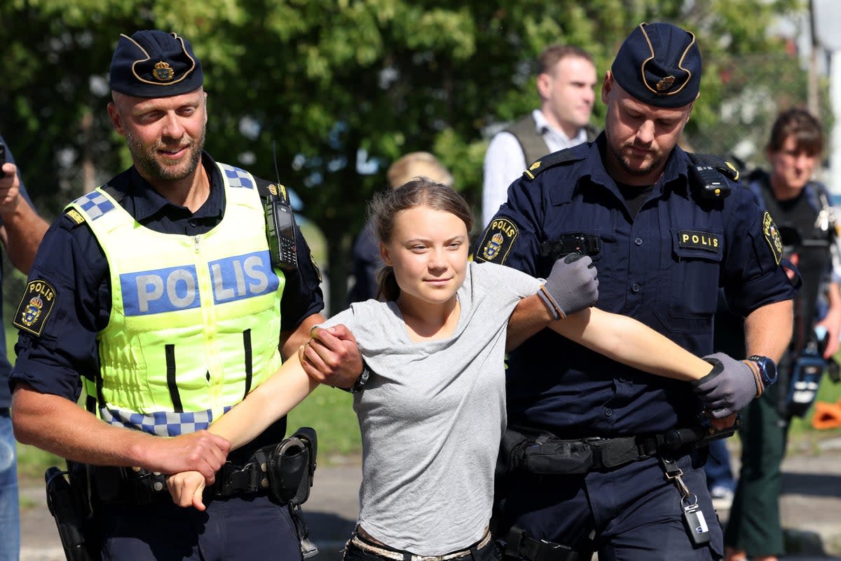 Greta Thunberg is carried away by police officers during a climate protest on July 24 (file photo)  (TT News Agency/AFP via Getty Ima)
